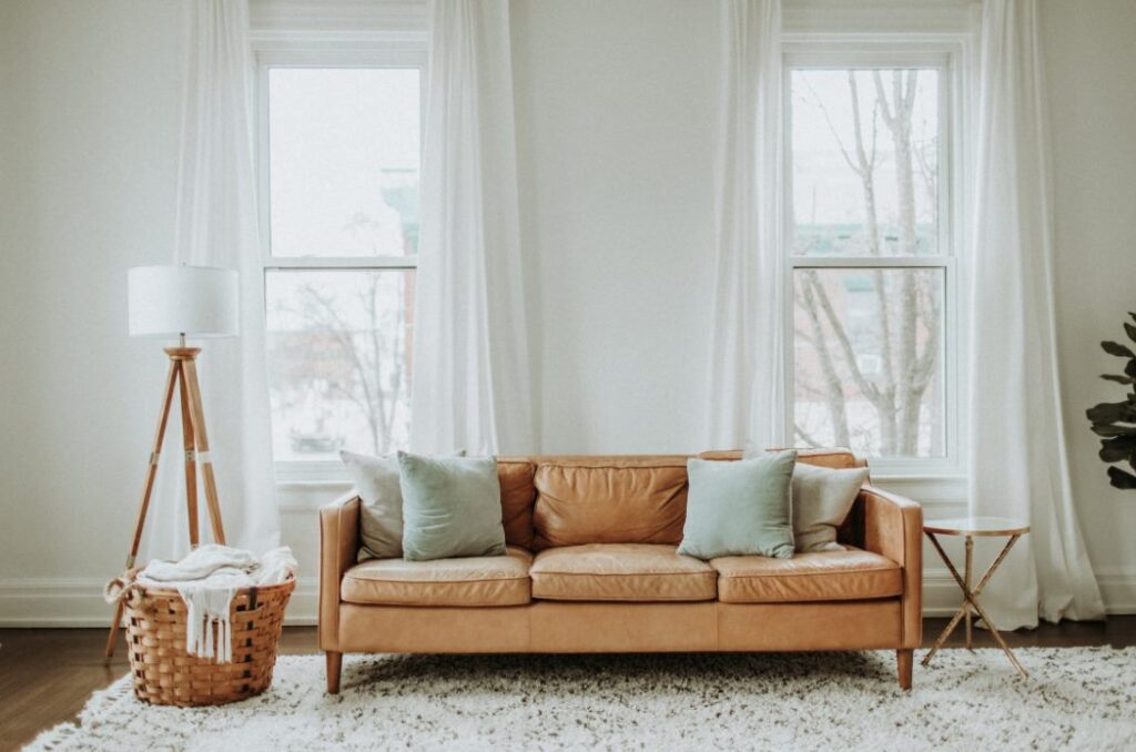 white and brown sofa chair near white window curta